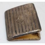 A George V silver pocket cigarette case having monogrammed cartouche, engine turned decoration,