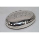 An early 20th century silver pocket snuff box of oval form, having monogrammed hinged cover