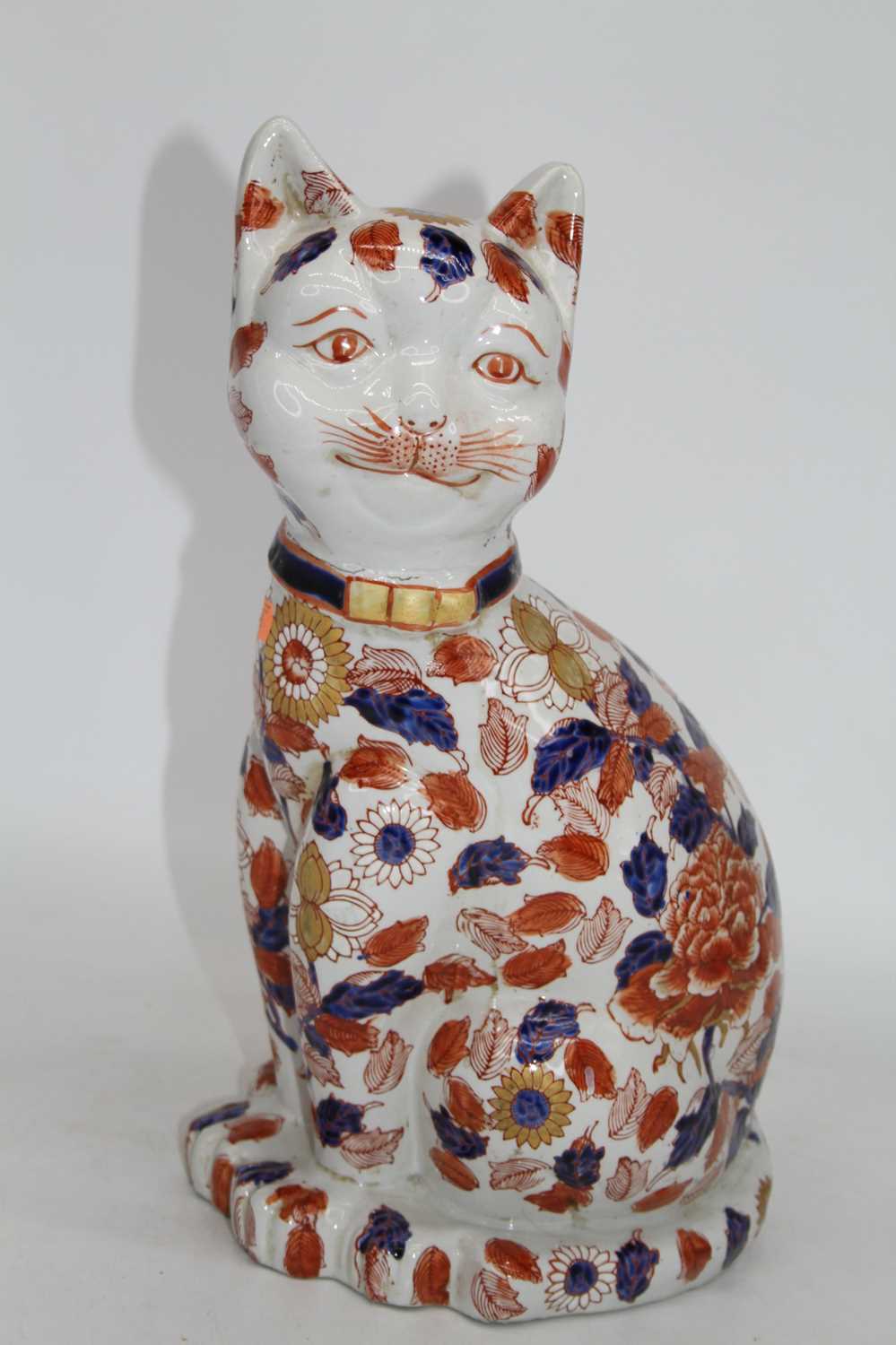 A modern Chinese pottery model of a cat, in seated pose, h.36cm