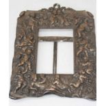 A Victorian Old Sheffield Plate easel photograph frame, repousse decorated with putti amongst