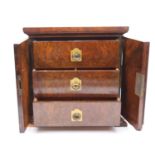 A 19th century burr walnut table top cabinet, the doors opening to reveal an arrangement of three