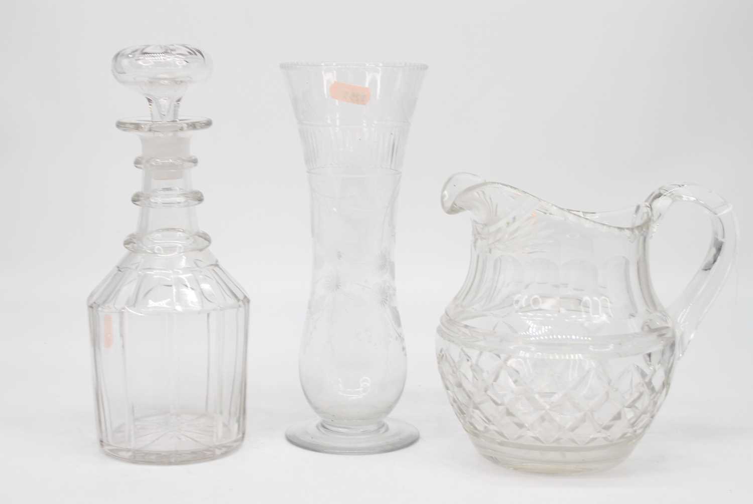 A Regency cut glass water jug, h.19cm; together with a triple ring neck decanter of mallet form; and