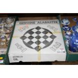 A polished alabaster chess set, boxed