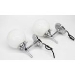 A pair of Art Deco style chrome wall lights with milk glass shades, height 21cm