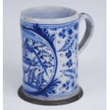 An English blue and white delftware tankard, 18th century, decorated with birds perched upon an