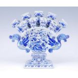 A Delft blue and white tulipiere, the thirteen tulip nozzles flanked by twin dragon handles,