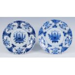 A pair of Delft blue and white plates, 18th century, each decorated with a vase of flowers within