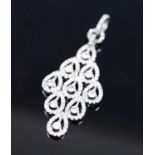 A white metal diamond set navette shaped multi-cluster pendant, comprising nine round brilliant
