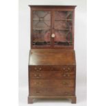 A George III mahogany bureau bookcase, the upper section having twin astragal glazed doors with