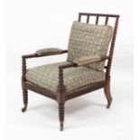 A Victorian rosewood bobbin turned armchair, having squab cushions and stuffover arms, further