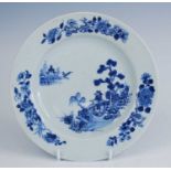 A Chinese blue and white porcelain plate, circa 1750, decorated with pagodas within a landscape,