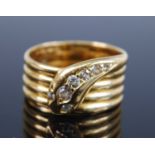 An 18ct yellow gold early 20th century snake ring, the head set with seven Old European cut diamonds