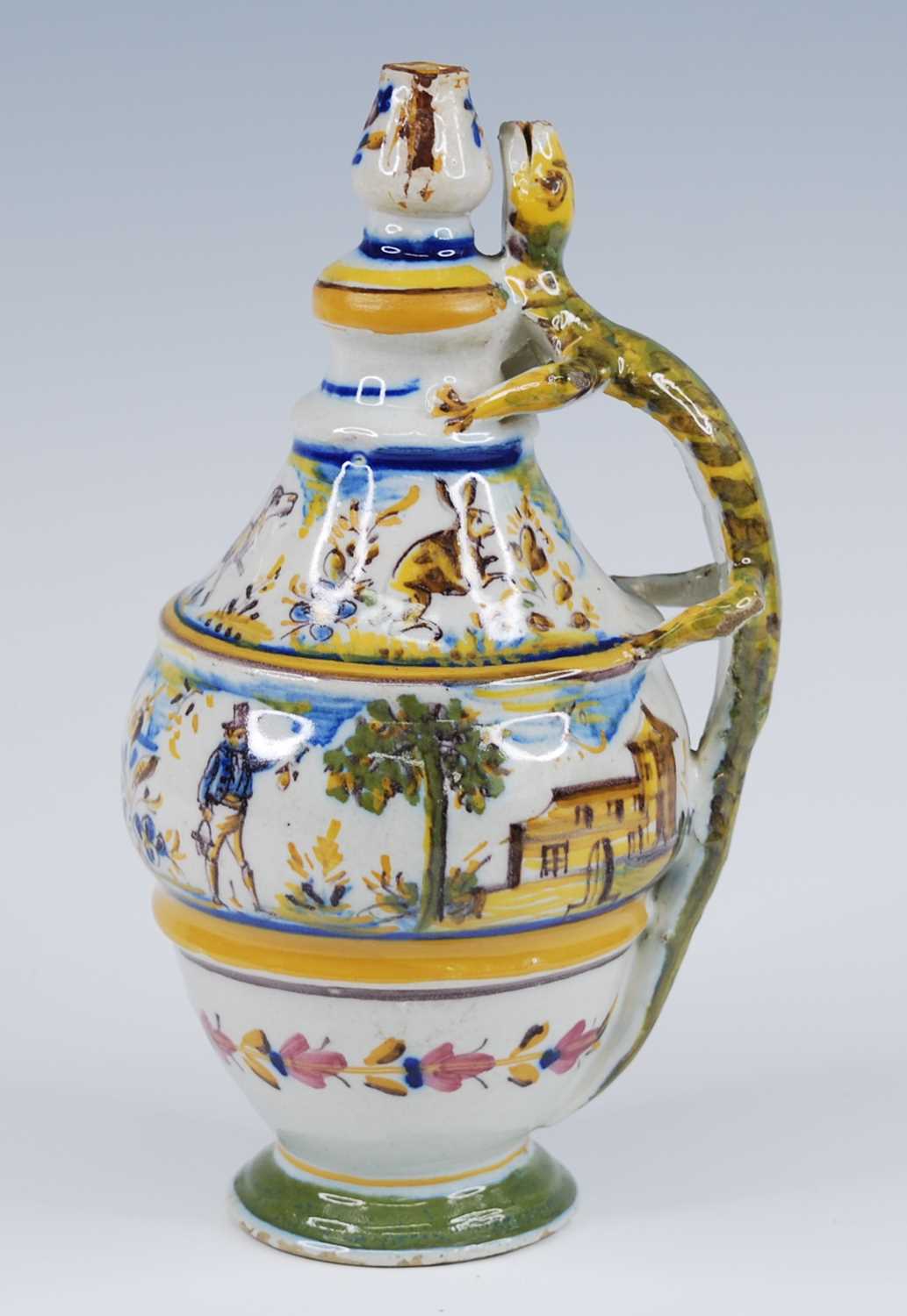 A Spanish grotesque polychrome glazed earthenware oil bottle, probably Alcora, 19th century, the