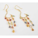 A pair of yellow metal multi-sapphire drop earrings, each comprising twelve oval faceted sapphires