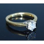 An 18ct yellow and white gold diamond single stone ring, featuring a round brilliant cut diamond