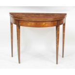 A circa 1800 mahogany and marquetry inlaid demi-lune card table, the fold-over top inlaid with a