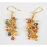 A pair of yellow metal multi-sapphire fringed drop earrings, each having 22 oval faceted sapphires