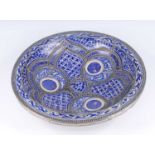 A Moroccan Fez blue and white glazed earthenware dish, early 20th century, with applied filigreework