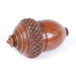 A 19th century coquilla nutmeg grater, carved in the form of an acorn, the screw cover opening to