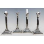 A set of four Queen Elizabeth II silver candlesticks, the stop-fluted Corinthian columns with