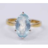 An 18ct yellow and white gold aquamarine single stone ring, featuring a marquise cut aquamarine in a