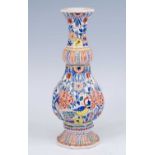 A Dutch Delft polychrome vase, 18th or 19th century, of reeded octagonal form, decorated with