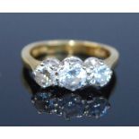 An 18ct yellow and white gold diamond three stone ring, comprising three graduated round brilliant