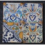 A matched set of three Dutch polychrome tiles, early 17th century, decorated with a tulip within a