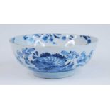 An English blue and white delftware bowl, probably Liverpool, circa 1750, decorated with flowers,