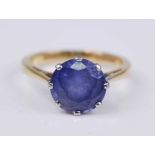 An 18ct yellow and white gold tanzanite single stone ring, featuring a round faceted tanzanite in an