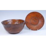 A 19th century elm bowl, having a ring tuned exterior, dia.27.5cm, together with a turned oak plate,
