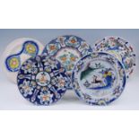 A collection of five Delft polychrome chargers, 18th century and later, of varying patterns, largest