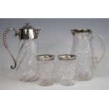 A late Victorian silver topped cut glass claret jug and two glasses, the crystal bodies with