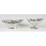 An Edwardian silver swing-handled pedestal basket, of oval form with a shaped reeded border and