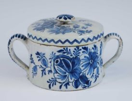 A Lambeth blue and white delftware posset pot or caudle cup and cover, circa 1750, flanked by twin