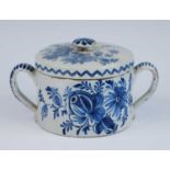 A Lambeth blue and white delftware posset pot or caudle cup and cover, circa 1750, flanked by twin