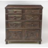 A Jacobean period oak chest, of two short and three long geometric moulded drawers, having a two-