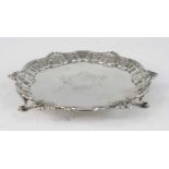 A George II silver card waiter, of shaped circular form, having a piecrust border embellished with