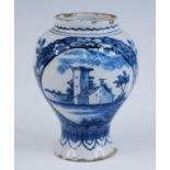 A Delft blue and white vase, 18th century, of baluster form, decorated with a church within a