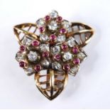 A yellow metal, ruby and diamond floral cluster brooch, featuring three flower motifs each with bold