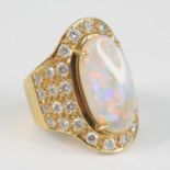 A modern yellow metal opal and diamond oval cluster ring, of good size, the four-claw set cabochon
