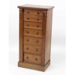 A Victorian oak Wellington chest, having seven long graduated drawers and acanthus leaf capped