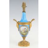 A French porcelain and gilt metal table lamp, early 20th century, of baluster form, flanked by