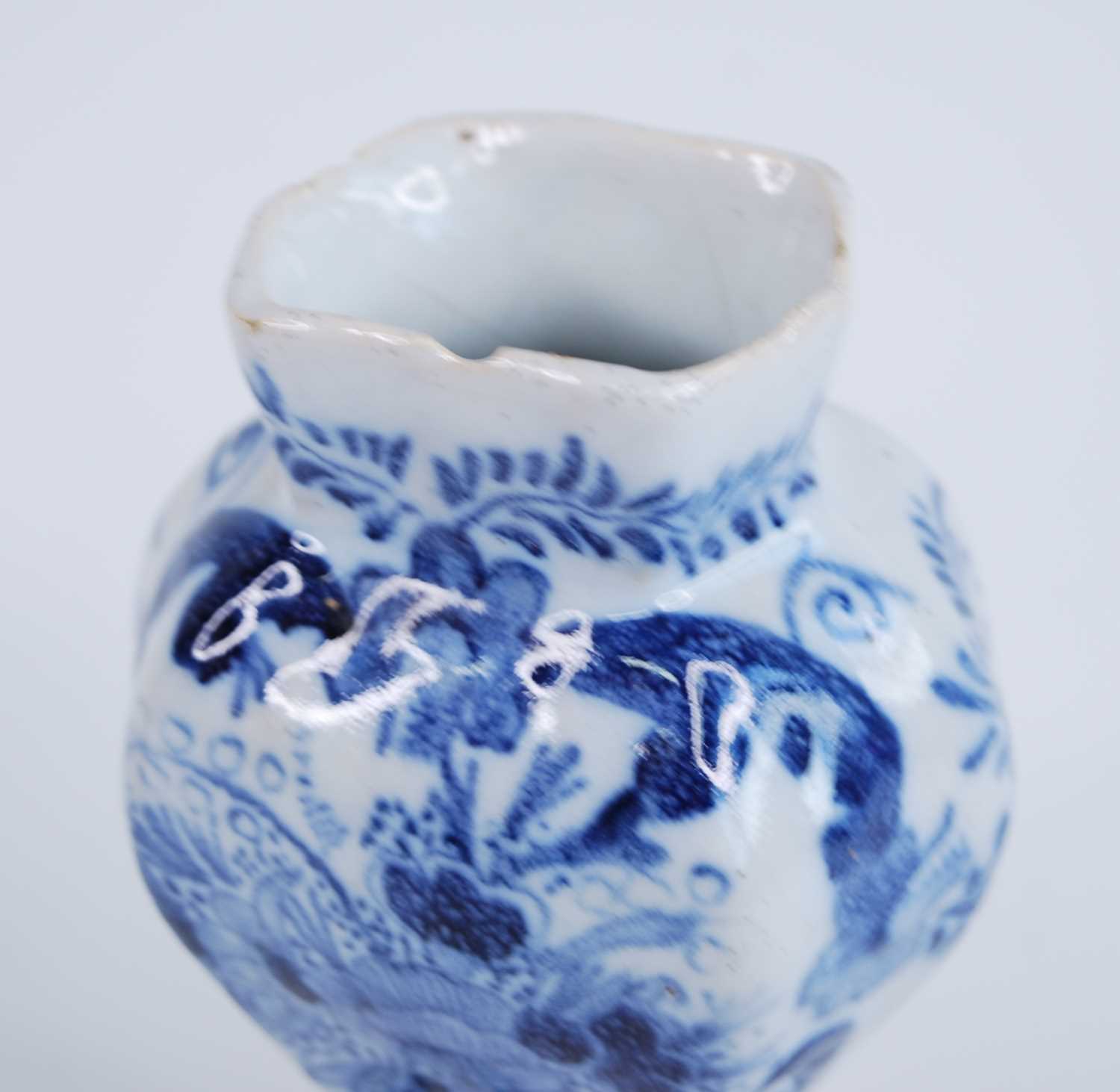 A Delft blue and white vase, 18th century, the garlic neck above a globular body, decorated with - Image 7 of 9