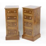 A pair of walnut and figured walnut bedside chests, each having a cross and feather banded top above