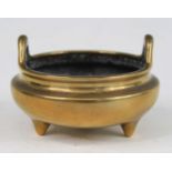 A Chinese gilt bronze miniature tripod censer, having simple loop handles, the base with Xuande
