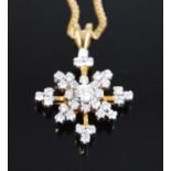 An 18ct yellow and white gold diamond star cluster pendant, featuring 33 round brilliant cut