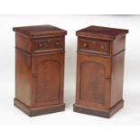 A pair of Victorian mahogany pot cupboards, each having a single frieze drawer over cupboard