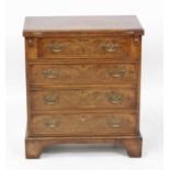 A walnut and figured walnut bachelors chest in the early 18th century style, having a cross and