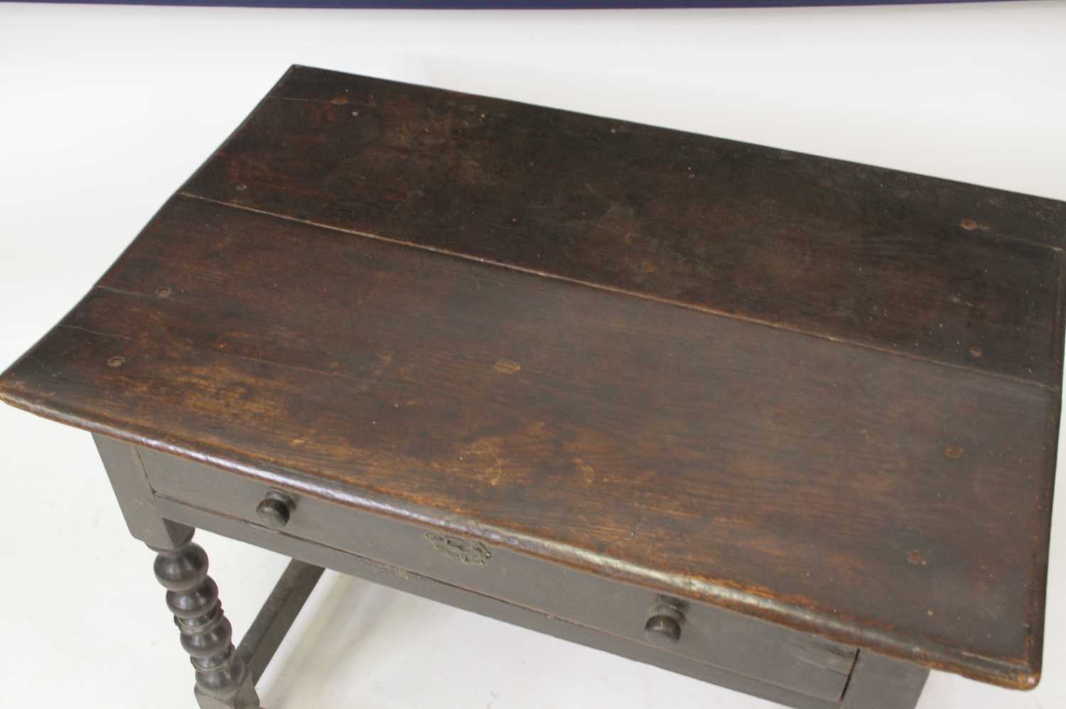 A circa 1700 joined oak single drawer side table, having a two-plank top and raised on bobbin turned - Image 2 of 4